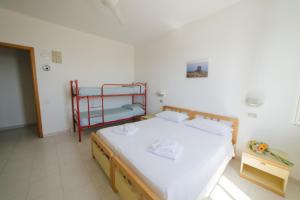 Giường trong phòng chung tại Albergo Marla