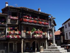 un edificio con cajas de flores en su lado en Apartamento La Muralla, en Miranda del Castañar