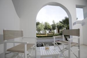 two chairs and a table on a patio at Garden Hotel Ripa in Vieste