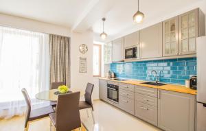 a kitchen with a table and a dining room at Seasons Mountain Suite in Braşov