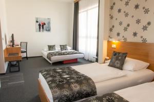 Postel nebo postele na pokoji v ubytování Hotel Delminivm