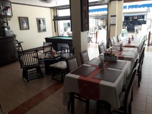 a dining room with tables and chairs and a pool table at Southern Fried Rice in Kata Beach