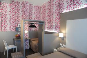 Postel nebo postele na pokoji v ubytování Hotel Astoria