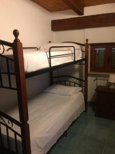 two bunk beds sitting in a room with at Marine Park Casa Vacanze in Scifo +72 photos