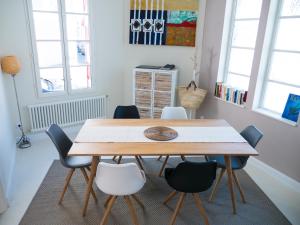 een eetkamer met een houten tafel en stoelen bij CAP BERILOU . Qualité et Confort Assuré . in Arcachon