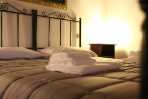 a bed with towels stacked on top of it at Hotel Ristorante Termitito in Scanzano