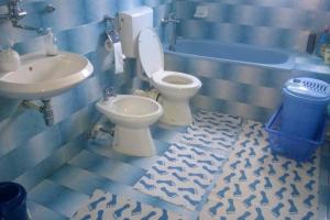 a bathroom with a toilet and a sink at Holiday Home Nana in Bugojno +48 photos