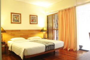 En eller flere senger på et rom på Rumah Turi Eco Boutique Hotel
