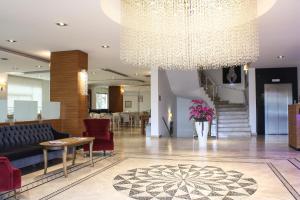 a lobby with a couch and a table and a chandelier at Tuna Hotel in Mugla