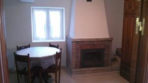 a dining room with a table and a fireplace at Lavin Etxea in San Esteban de Galdames