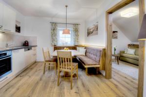 a kitchen and dining room with a table and chairs at Gasthaus Brandlwirt in Saalfelden am Steinernen Meer