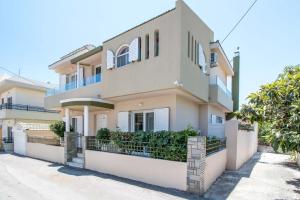 a large house with a fence in front of it at Kalithies Village Villa in Kallithea Rhodes