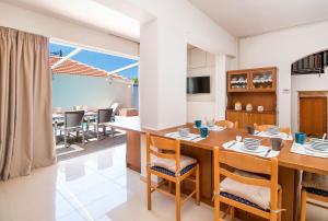 a kitchen and dining room with a table and chairs at Kalithies Village Villa in Kallithea Rhodes