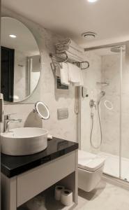 a bathroom with a sink, toilet and bathtub at Smart Hotel İzmir in İzmir