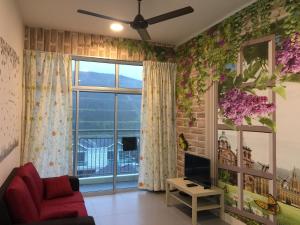 a living room with a couch and a window at Cameron DreamWorld Apartment @ Golden Hill in Cameron Highlands
