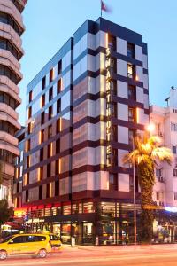 a city street with tall buildings and a tall building at Smart Hotel İzmir in İzmir