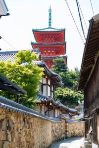 a building with a tower in the background at 島泊 島飯 島湯 in Tonosho