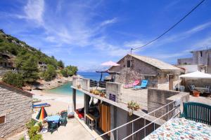 a view of the beach from the balcony of a house at Robinson Braco in Bogomolje
