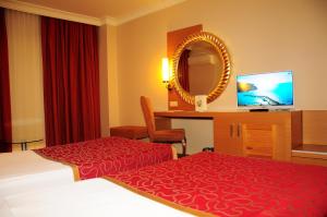 A television and/or entertainment centre at Alaiye Resort & Spa Hotel - Ultra All Inclusive