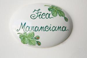 a white plate with a sign for a sign manufacturer at Antica Masseria Ficazzana - Tenuta in Marina di Pescoluse