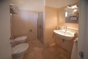 a bathroom with a toilet and a sink and a shower at Antica Masseria Ficazzana - Tenuta in Marina di Pescoluse