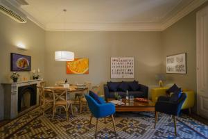 a living room with a couch and a table and chairs at Bcn Paseo De Gracia Rocamora Apartment in Barcelona