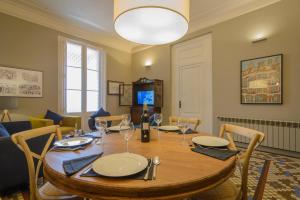a dining room with a wooden table and chairs at Bcn Paseo De Gracia Rocamora Apartment in Barcelona