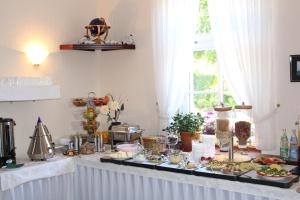 a buffet with food on a table at Baltisches Haus Pension Moll in Zinnowitz