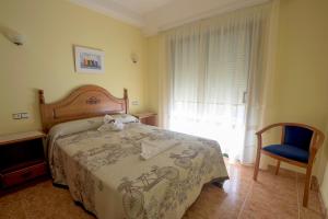 Posteľ alebo postele v izbe v ubytovaní Hostal O Camouco
