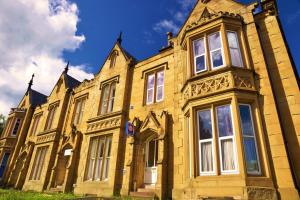 a large yellow brick building with many windows at Edgerton Hotel in Huddersfield