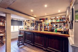 a bar in a pub with a bar stool at The Lord Nelson in Sutton upon Trent