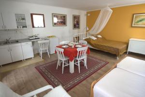 a living room with a table with a red table cloth at Apartment Honey and milk in Vrdnik