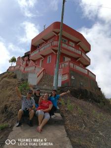 un groupe de personnes assises devant un bâtiment dans l'établissement Gira Lua, à Igreja