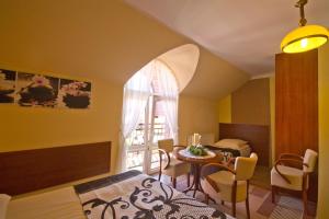 a room with a bed and a table and a window at Villa Tropikana in Łeba