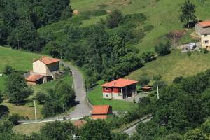 a house on the side of a hill with a road at Apartments Aurora in La Robellada de Onis