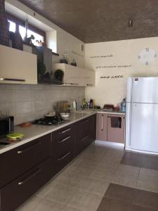 a kitchen with a white refrigerator and a stove at Villa Life in Zatoka