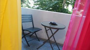 a small table and a chair on a balcony at Catalans in Marseille