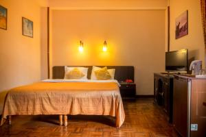 Cama ou camas em um quarto em Hotel Excelsior