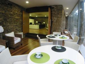 a dining room with two tables and chairs at Quinta dos Castanheiros - Turismo Rural in Negreda