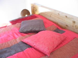 a bed with four pillows on top of it at Quinta dos Castanheiros - Turismo Rural in Negreda
