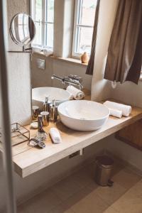 a bathroom with two sinks and a mirror at Landhotel Lammershof in Birkenau