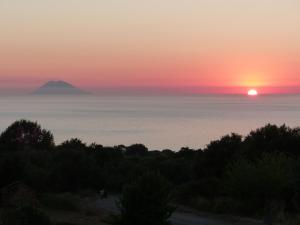 a sunset over the ocean with a mountain in the distance at Gullo Capo Vaticano in Ricadi +98 photos