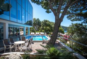 a patio with a table and chairs next to a building at Royal Neptun Hotel in Dubrovnik