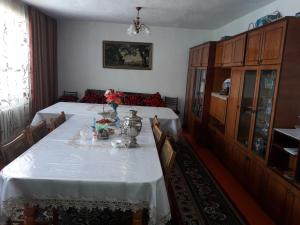 a dining room with a table with flowers on it at Guest House Baytur in Kochkor