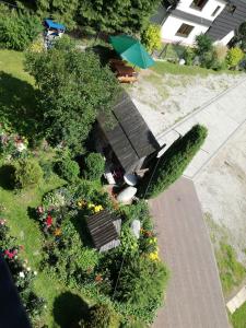 an overhead view of a park with a bench and flowers at Babiarzowie in Białka Tatrzańska