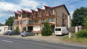 a building with cars parked in front of it at Motel Don Tomaso in Vaslui