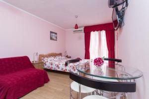 a bedroom with a bed and a glass table at Djurovic Apartments Montenegro in Kotor