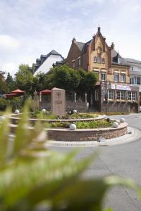 a building with a monument in the middle of a street at Hotel Eisbach in Ransbach-Baumbach