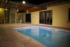 a swimming pool in the middle of a house at Divine Guest Lodge in Rustenburg