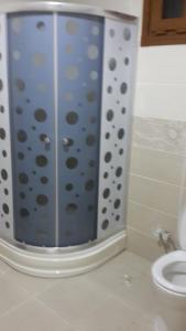 a shower with a polka dot shower curtain in a bathroom at AYDER ŞAFAK Apart in Ayder Yaylasi +4 photos